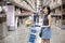 Medium shot of An asian woman doing shopping  and walking with her cart in cargo or warehouse