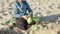 Medium shot of focused little boy playing in sand on beach