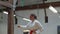 Medium shot of focused teenager practicing karate in gym