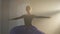 Medium shot of graceful slim ballerina in tutu spinning in backlit fog in second and fifth position. Elegant beautiful