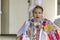 A medium shot of an Indigenous woman talent showcase wearing a white traditional dress.