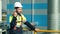 Medium shot male builder wearing uniform using walkie talkie at construction site