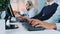 Medium shot of operators hands typing on keyboard in modern office