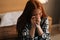 Medium shot portrait of unhappy depressed redhead woman crying and wiping tears with paper tissue, suffer from grief