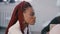 Medium shot portrait of young positive African American office corporate employee focused at team meeting behind table.