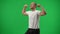 Medium shot satisfied Caucasian football player putting ball down gesturing strength at chromakey background template