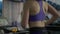 Medium shot slim unrecognizable sportswoman jogging on treadmill in gym. Motivated confident young Caucasian woman