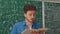 Medium shot of teacher with book holding math class