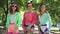 Medium shot three confident laughing Caucasian retro women in sunglasses and 1990s clothes posing in slow motion