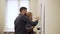 Medium shot of Young man and woman draw a graph on white board in office