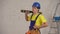 Medium video of a smiling young construction worker wearing a tool belt placing a construction water level on his