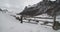 Medium view of a entrance of a farm in the mountains covered by snow