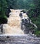 Medium waterfall cascade fall in Jukankoski Russian Karelia. Summer forest