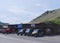 Medium wide street view with cars and ATVs parked outside wooden shops in Jackson Hole