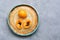 Medlar on a plate, gray background. Top view, copy space.