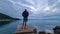 Medveja - A man in shorts standing on a stony pier of a beach