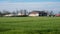 Meerhout, Antwerp Province, Belgium - Green field with the Biogas energy plant Boonen in the background