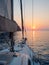 Meet the sunset in the Bay on Board the yacht, a romantic evening at sea. Boat trip on a yacht under sail.