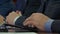 At a meeting of businessmen, a man prints on a tablet, conducts a dialogue and makes corporate decisions