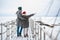 A meeting of a couple in love in winter on a pier on a frozen lake