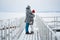 A meeting of a couple in love in winter on a pier on a frozen lake