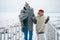 A meeting of a couple in love in winter on a pier on a frozen lake