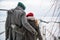 A meeting of a couple in love in winter on a pier on a frozen lake