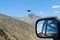 Meeting with eagle on the mountain pass in the car with rear vie