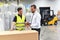 Meeting of the manager and worker in the warehouse - forklift an