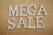 Mega Sale alphabet letters on wooden background business concept