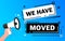 Megaphone blue banner with we have moved sign. Vector illustration