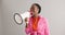 Megaphone, excited and black woman on gray background for news, announcement and information. Bullhorn, communication