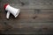 Megaphone make an announcement on dark wooden background top view copy space