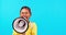 Megaphone, noise and face of girl child screaming in studio message, broadcast or speech on blue background. Speaker