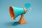 Megaphone with speech bubble on blue background