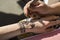 Mehendi Indian Painting on his hands, applied drawing paste.