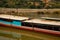 Mekong river, Laos and Thailand at Huay Xai. Traditional wooden boats at sunset