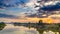 Mekong River Pakse Laos sunset dramatic sky reflection on water village on riverbank travel destination in South East Asia