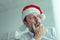 Melancholic businessman with Santa Claus hat suffering from Christmas holiday season depression