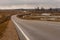 Melancholic winding drive at countryside from left