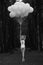 Melancholy. Lonely Woman with Balloons in Dark and Gloomy Forest