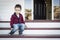 Melancholy Mixed Race Boy Sitting on Front Porch Steps