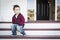 Melancholy Mixed Race Boy Sitting on Front Porch Steps