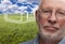 Melancholy Senior Man with Grass Field and Ghosted House Behind