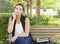 Melancholy Young Adult Woman Sitting on Bench Next to Books