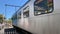 Melbourne, Victoria, Australia -Circa 2020s : Blue and silver train crosses a street.