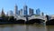 Melbourne, Victoria, Australia. Skyscrapers and the bridge over the Yarra river. Boat passes through the Princes Bridge