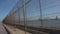 Melilla border fence seen from a car. Border of Spain with Morocco