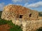 MELLIEHA, MALTA - Feb 14, 2014: A Maltese girna. a traditional hut built from irregular stones in fields, by farmers for shelter