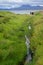 Mellon Udrigle, Scotland: Three women walk along a creek filled with wildflowers at Mellon Udrigle Beach